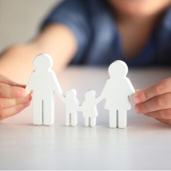child holding family image that looks like paper dolls