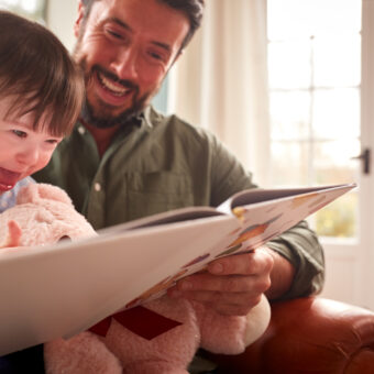Father and son reading a book together